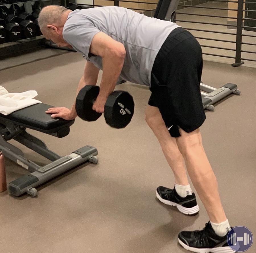 Client performing single-arm dumbbell rows