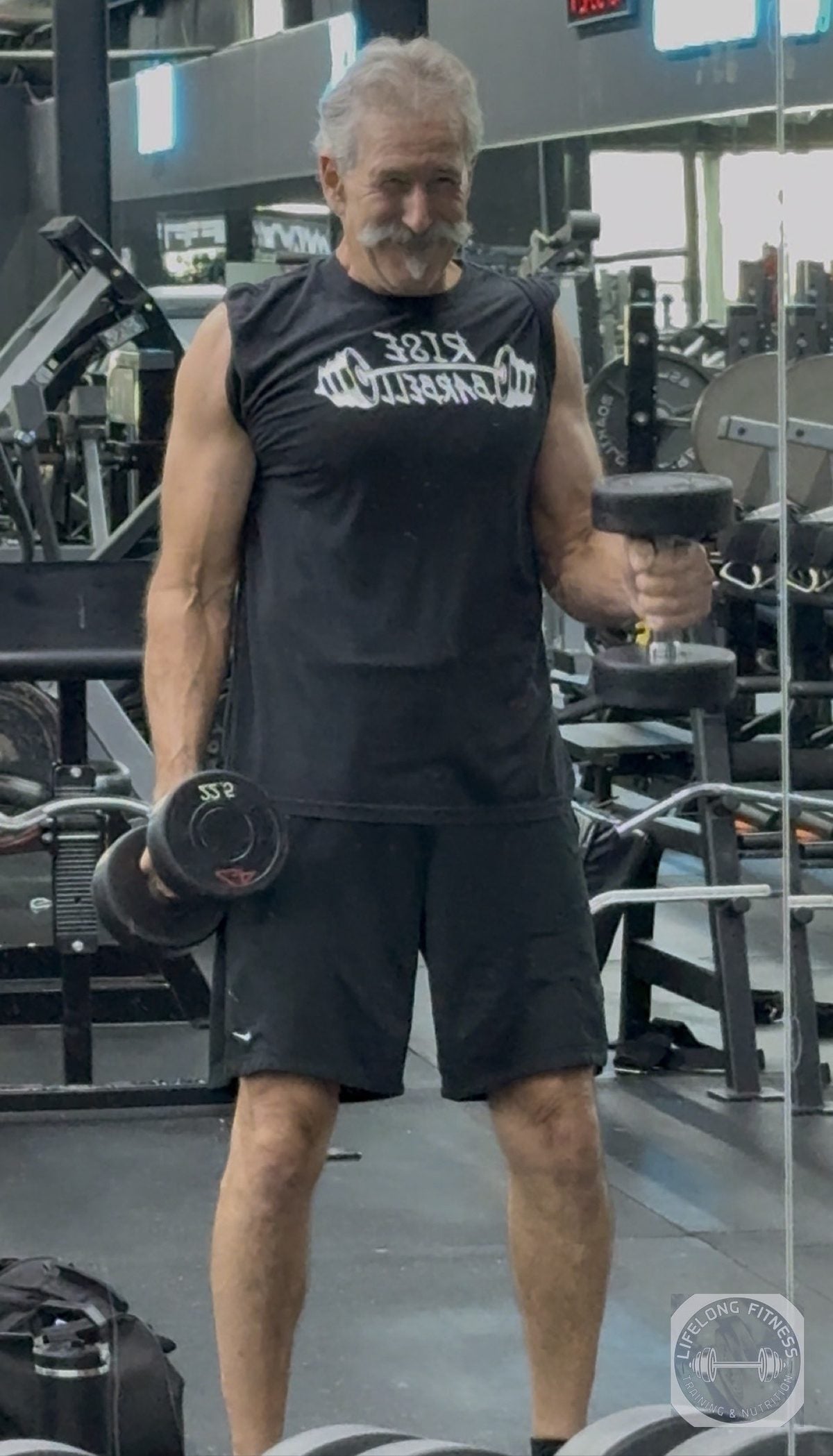 Client doing dumbbell curls at Rise Gym