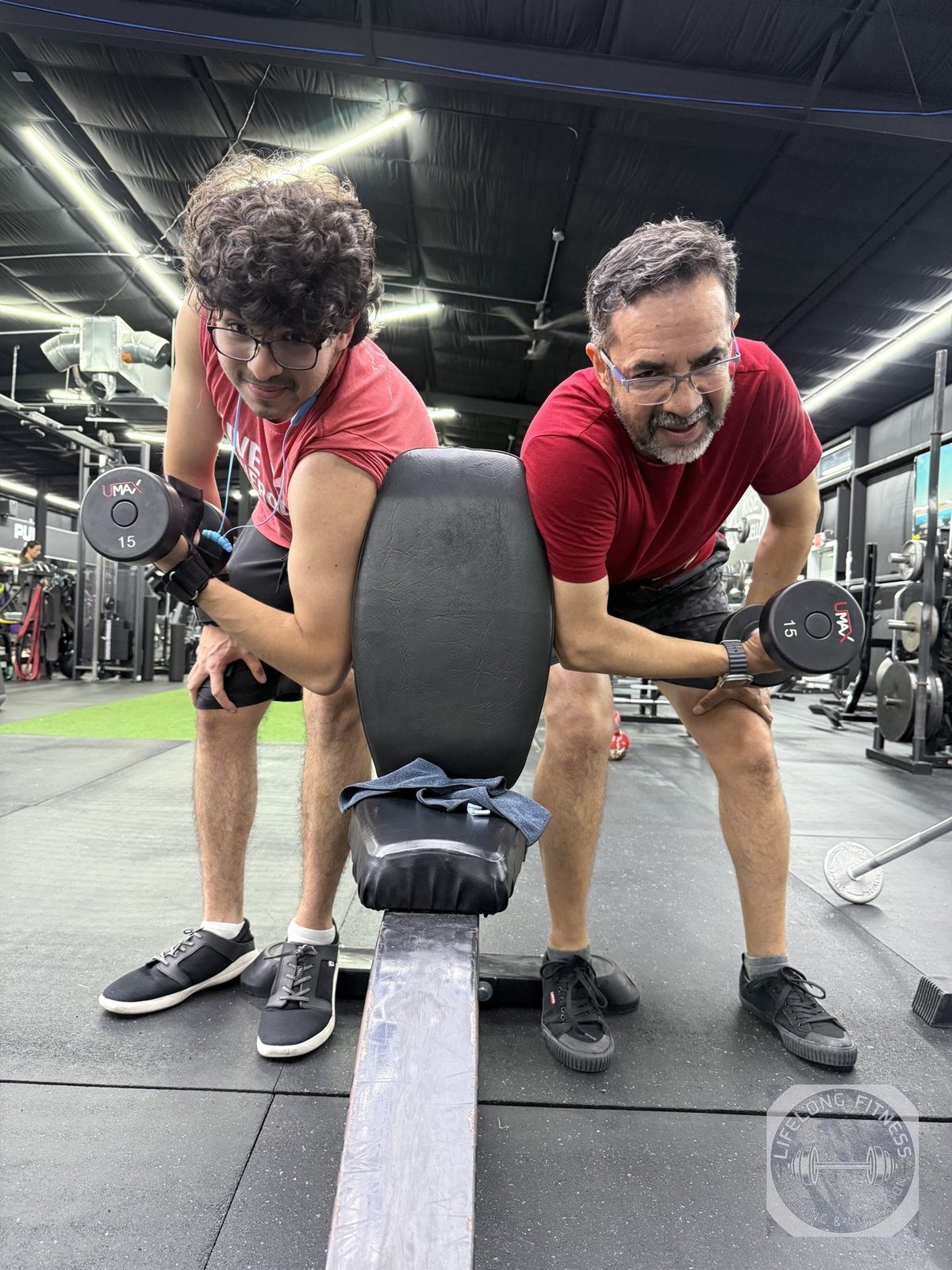 Two clients doing dumbbell rows at Rise Gym